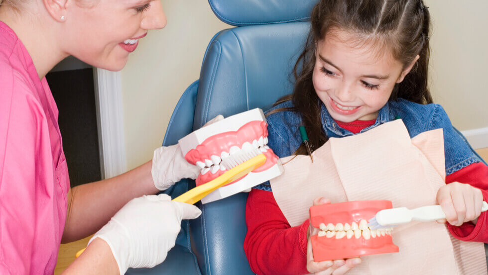 Children’s Dentistry Doctor explaining teeth anatomy to a kid